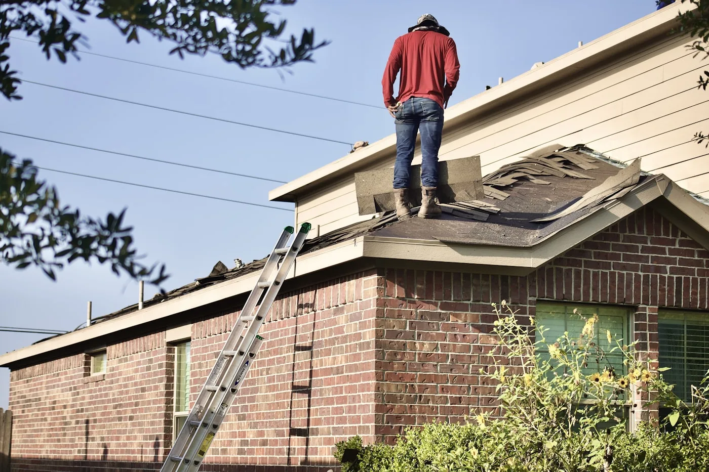 Roofing work underway on a brick home